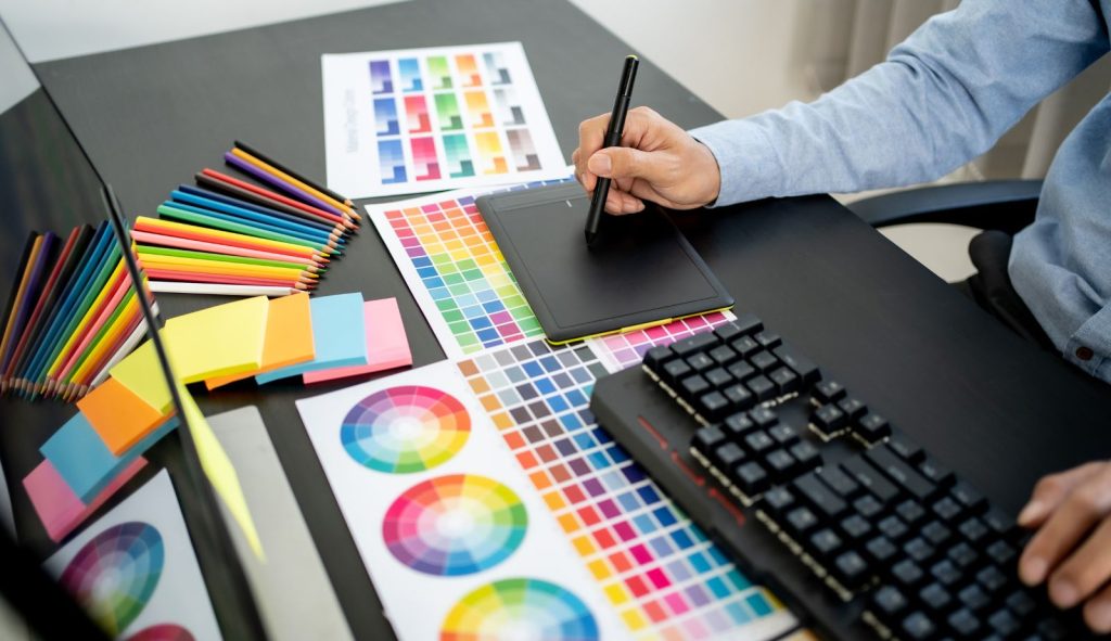 An image of a Harrisburg, PA Graphic designer working on designs for a local plumbing business.